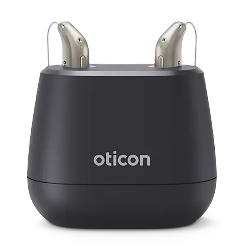 Oticon Intent rechargeable hearing aids in their desktop charger