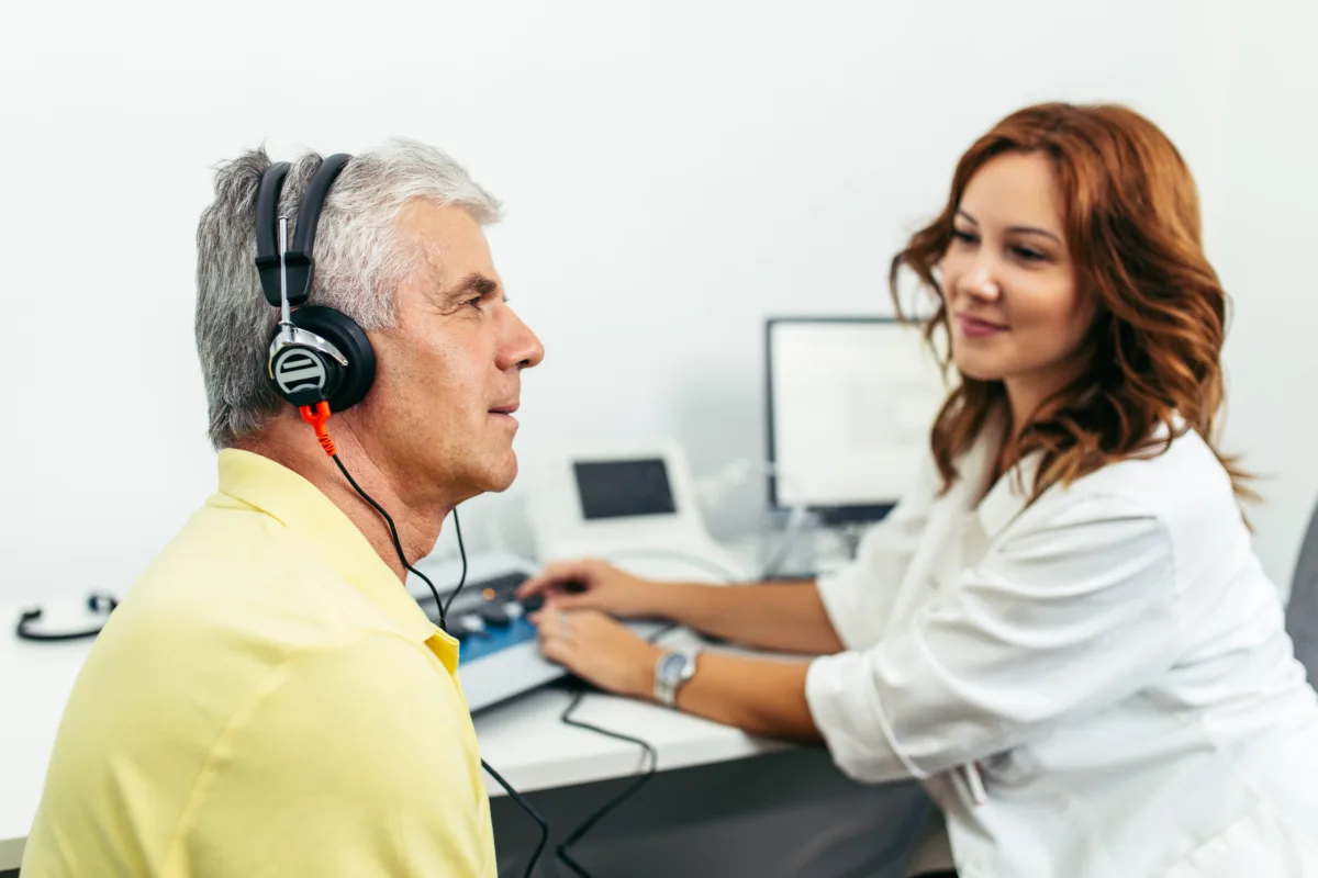 Audiologist carrying out a hearing test with a patient wearing audiometric headphones at The Hearing Team clinic in Birmingham